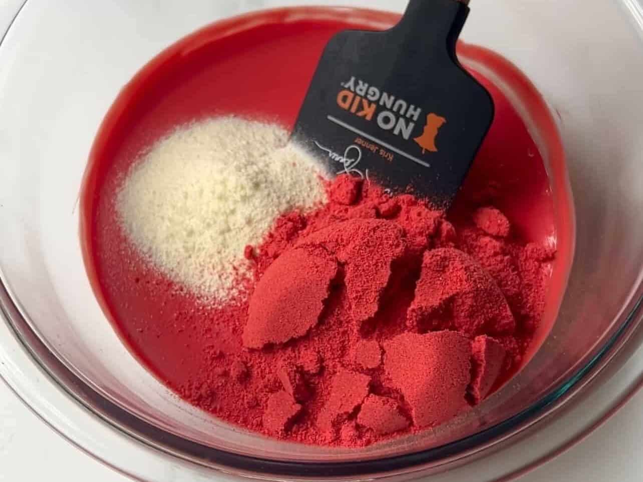 combine melted candy melt and sieved dry milk powder and freeze-dried strawberries