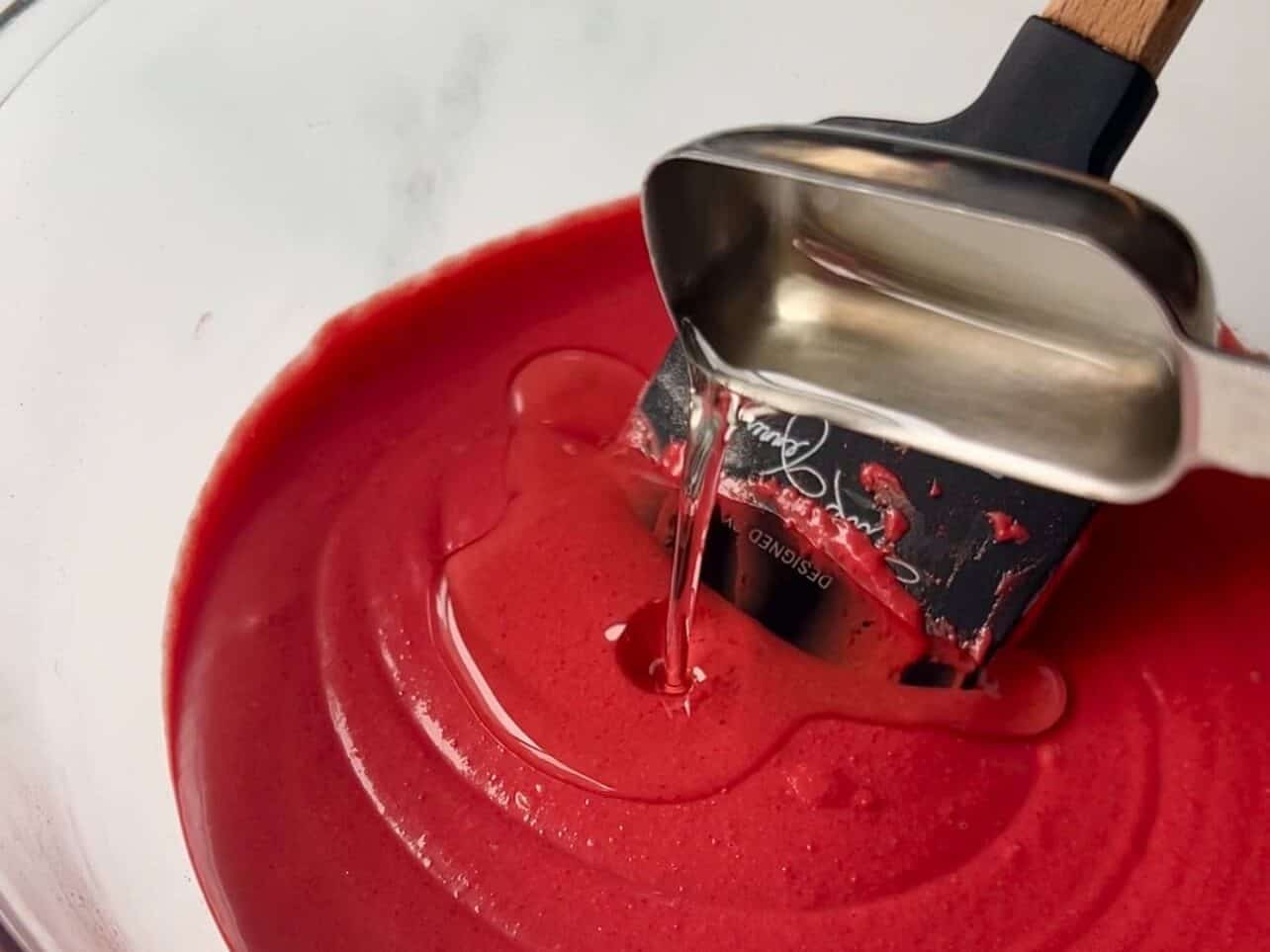 adding oil to thin candy melt consistency to coat cake pops