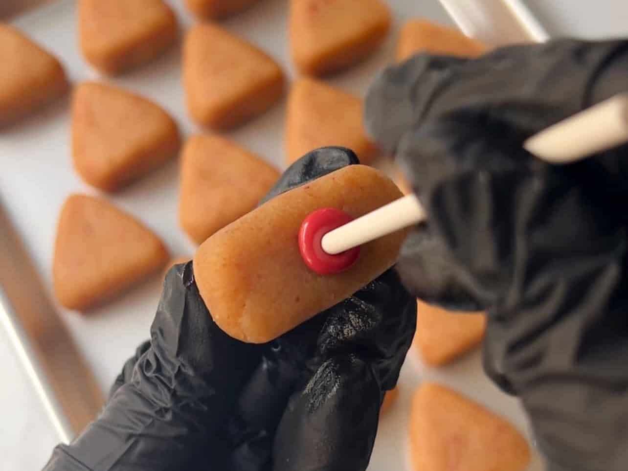 insert dipped stick into center of strawberry cake pop