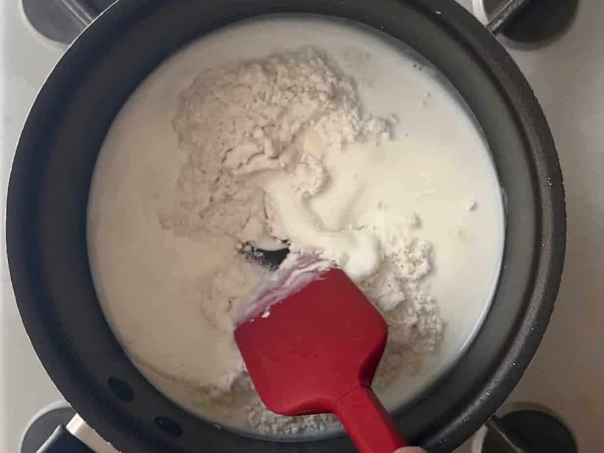 Stirring flour and water in a small sauce pan to create a tangzhong paste