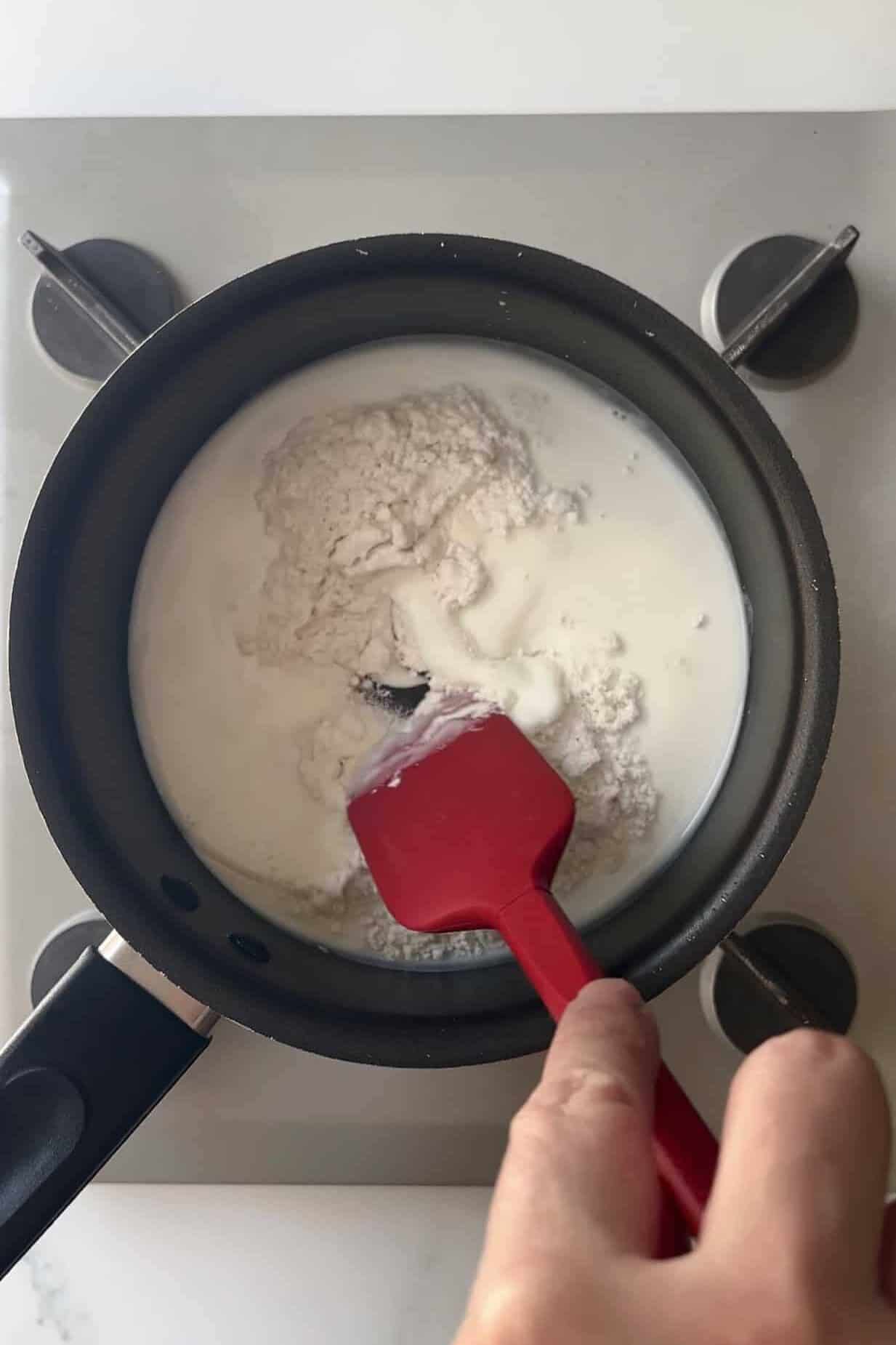 Stirring flour and water in a small sauce pan to create a tangzhong paste