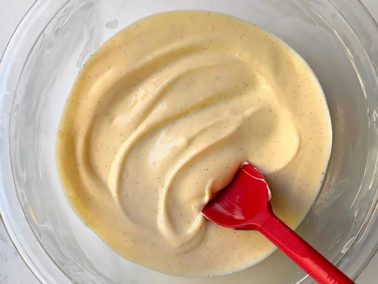 smooth creamy cheesecake filling filled with vanilla bean specks in a bowl ready to scoop