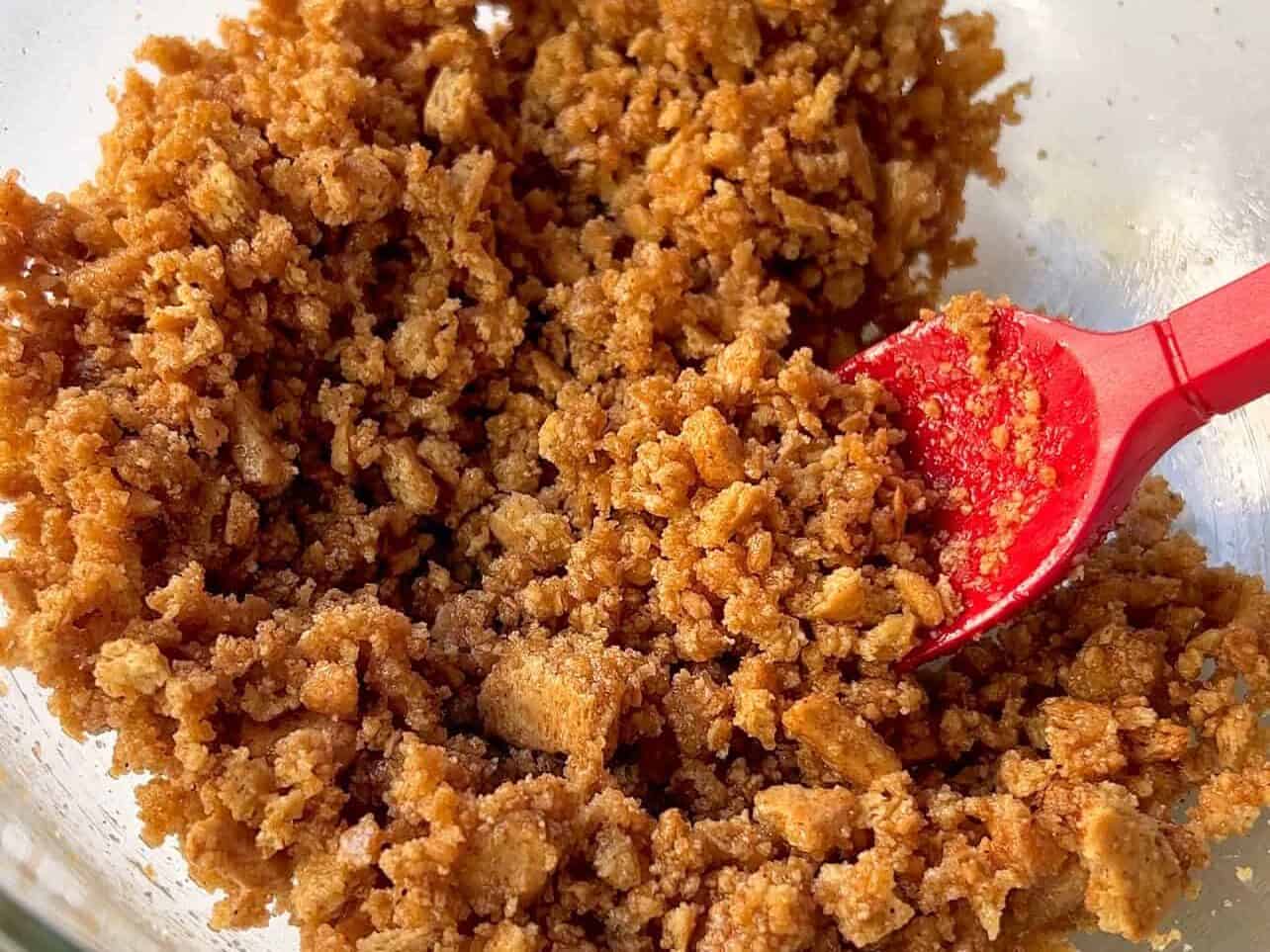 graham cracker crumble in bowl ready to sprinkle onto blueberry lemon cheesecake crumble brioche rolls