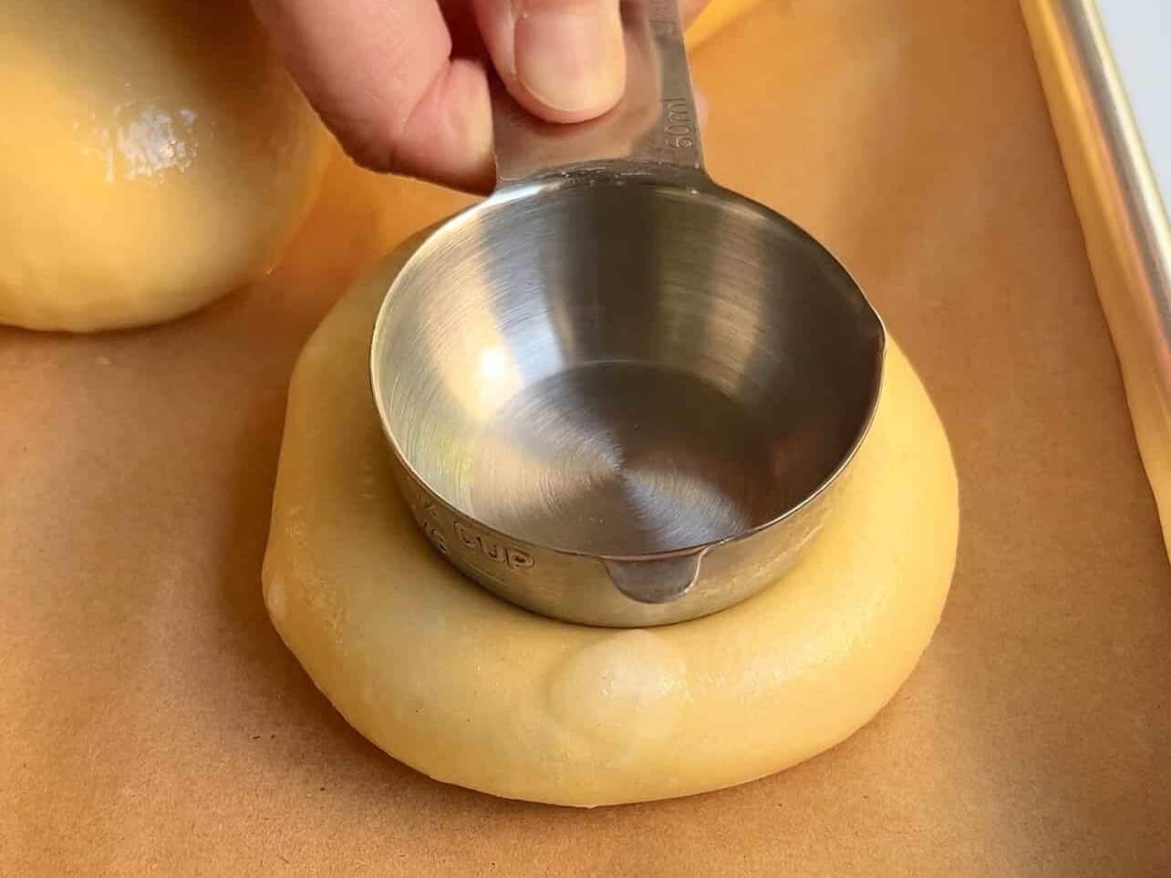 create a center crater in brioche roll to fill with cheesecake filling
