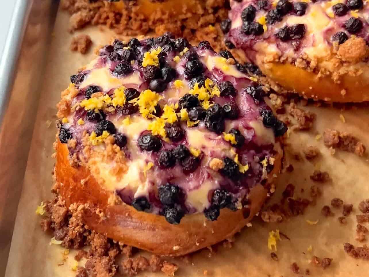 Blueberry Lemon Cheesecake Crumble Brioche Rolls baked on sheet tray