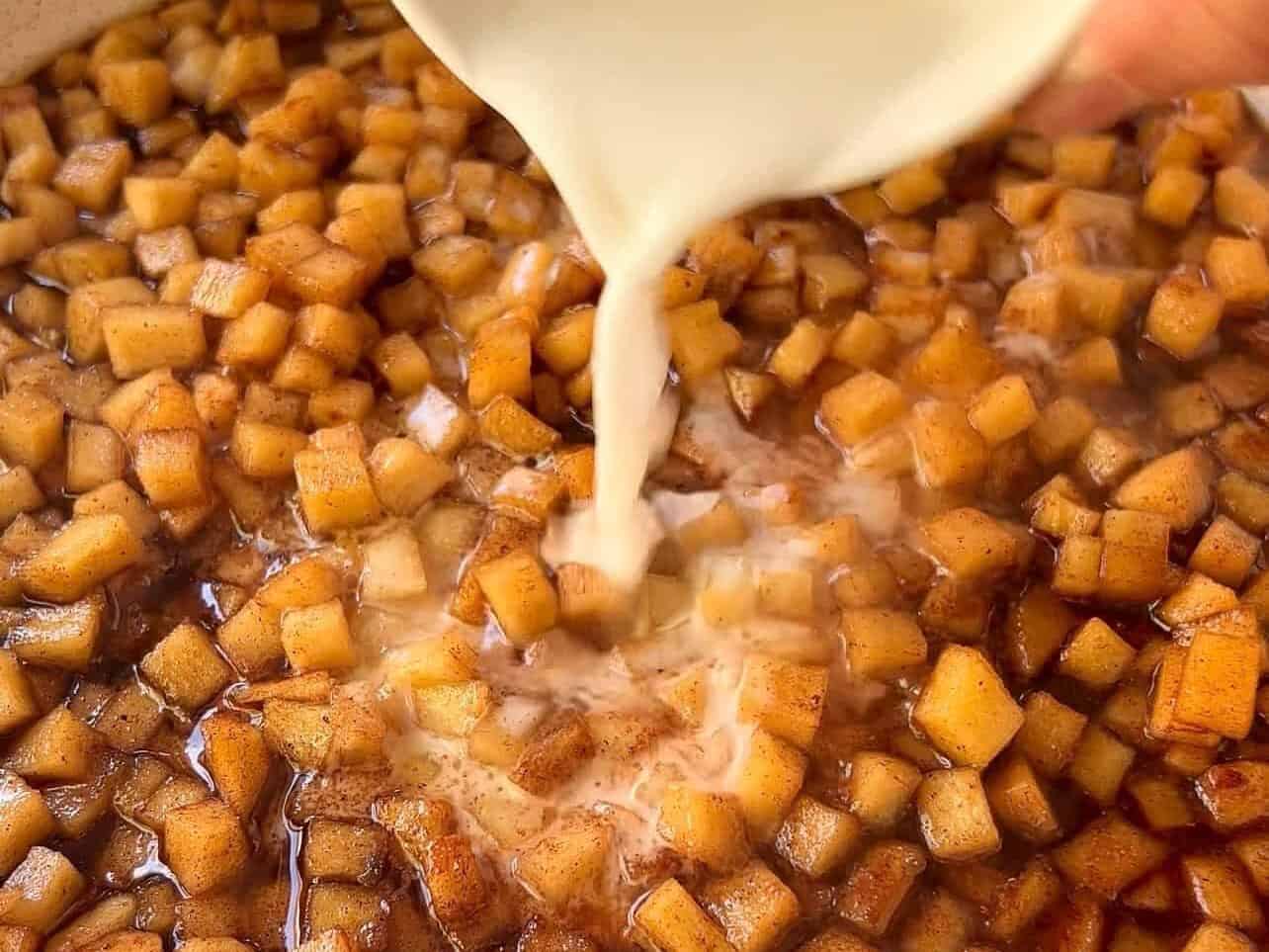 adding slurry. to apple pie filling in large skillet
