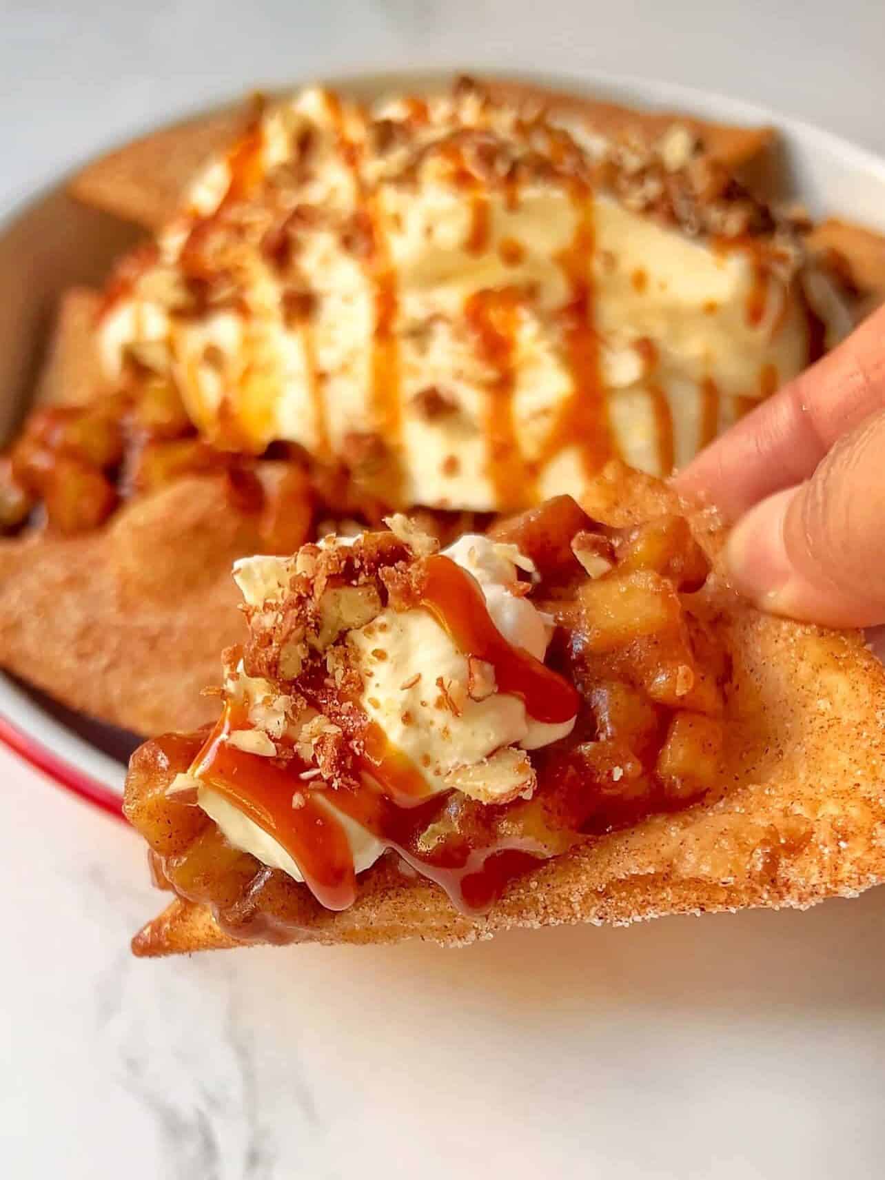 loaded apple pie nacho chip with apple pie filling, caramel drizzle, and chopped candied pecans