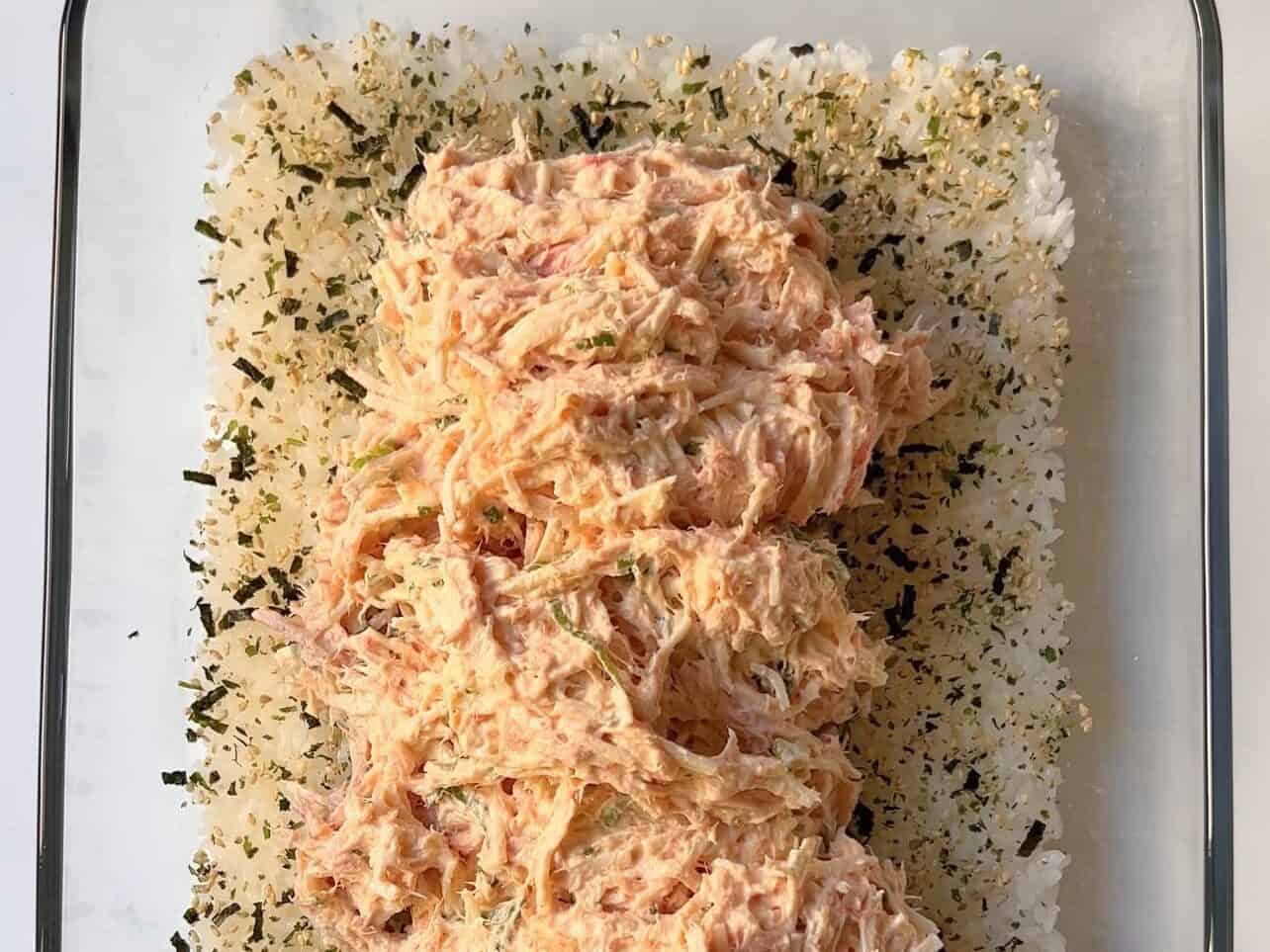 assemble sushi bake with sushi rice, furikake, and seafood mixture
