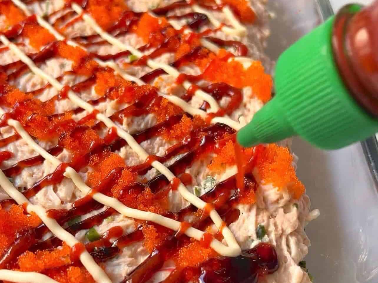 top sushi bake with sriracha, kewpie mayo, masago, and other toppings
