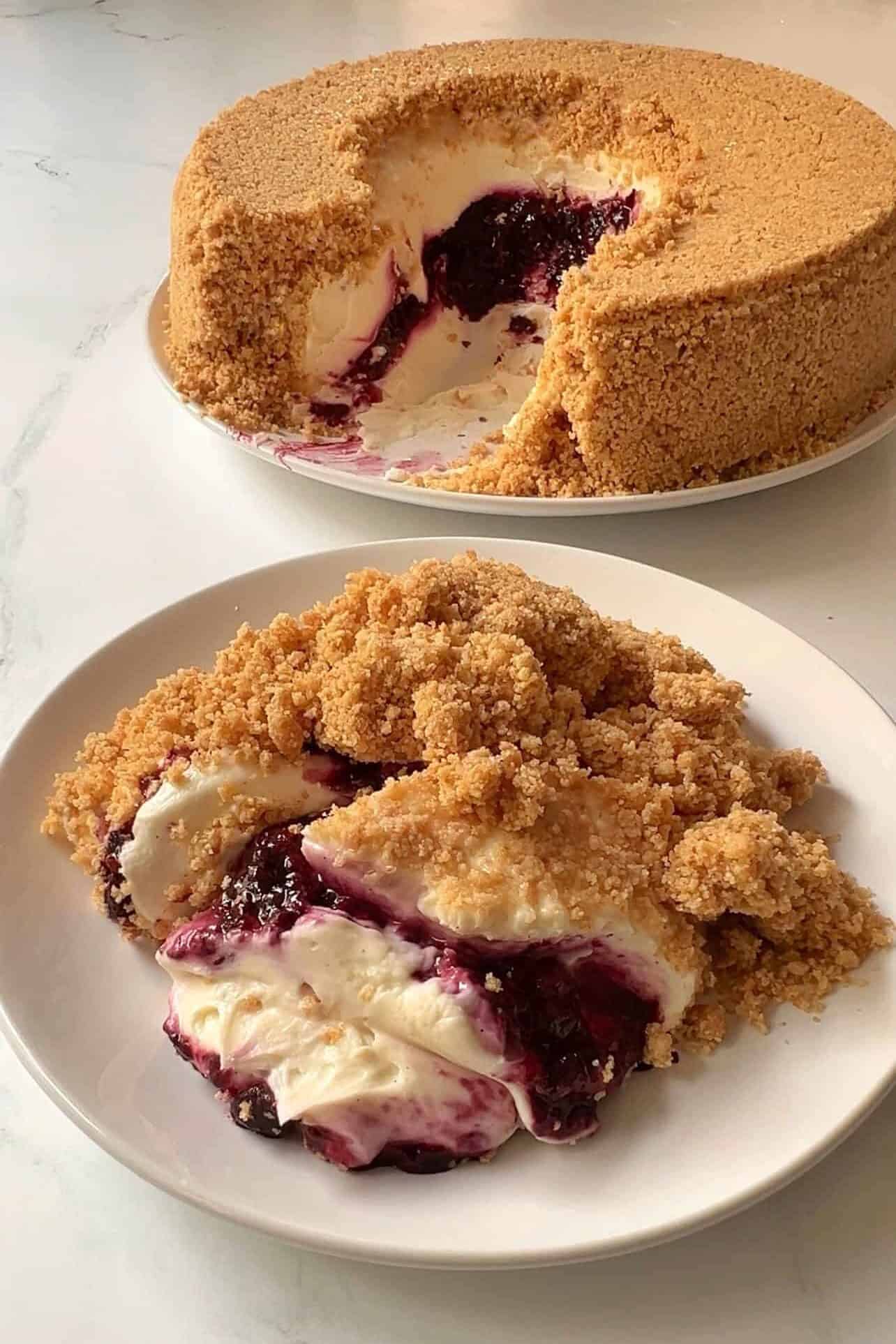 plate showing scooped slice of upside down cheesecake with berry compote