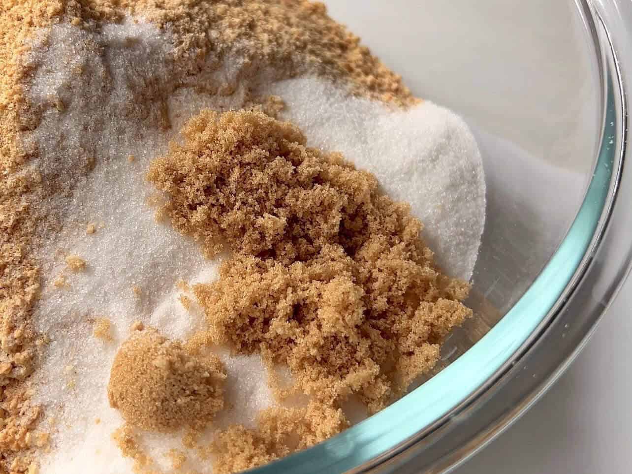 white and brown sugar added to crush graham crackers to make cheesecake crust