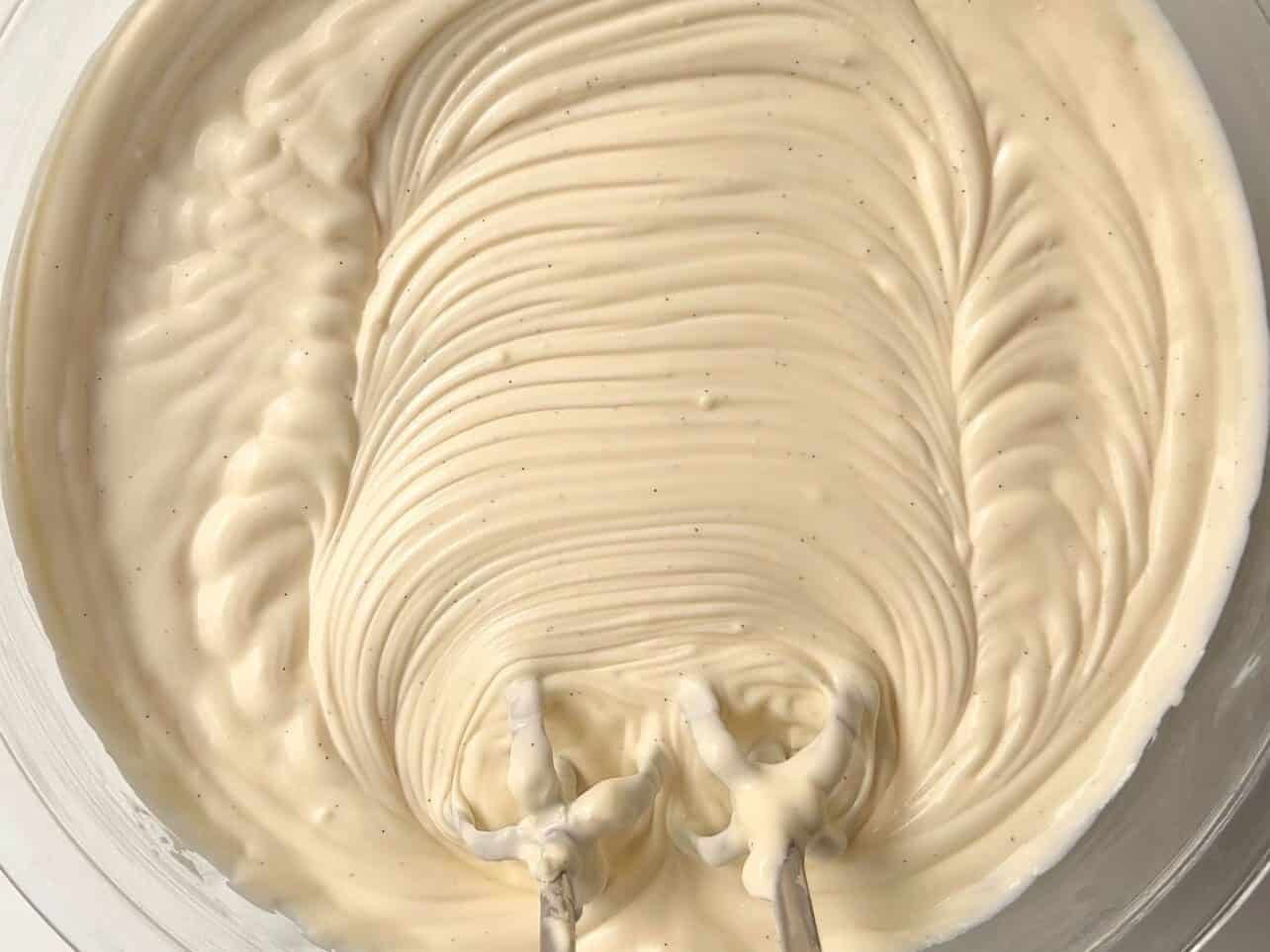 whipping thick cheesecake filling in large mixing bowl