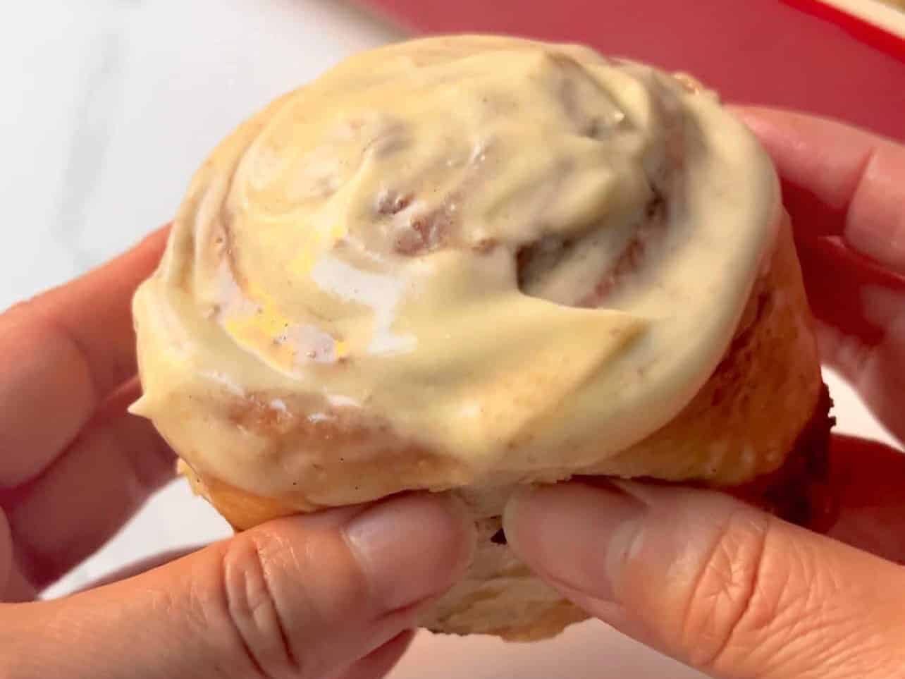 Cinnabon copycat cinnamon roll held ready to be enjoyed