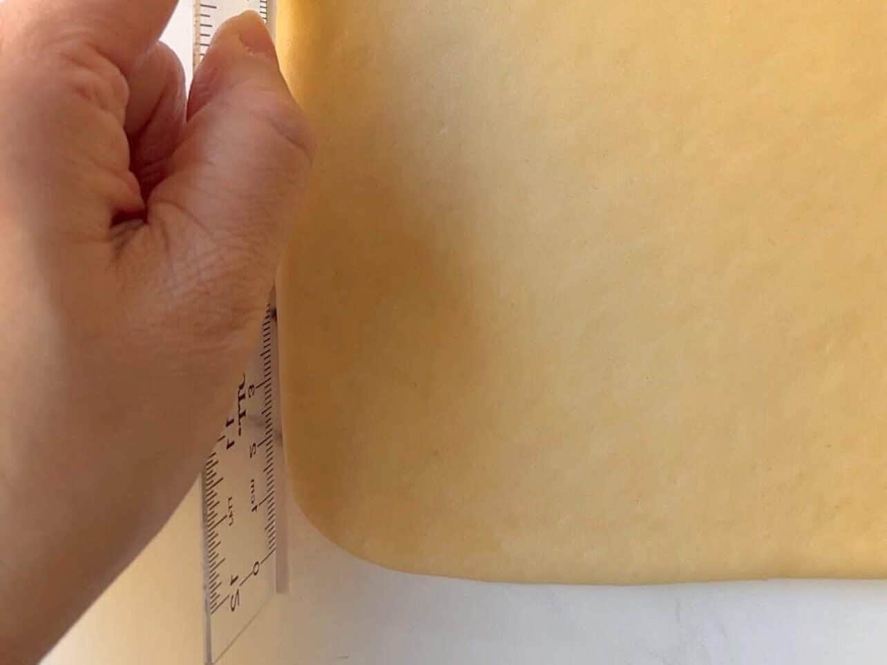 use of rulers to help achieve straight sides when rolling dough