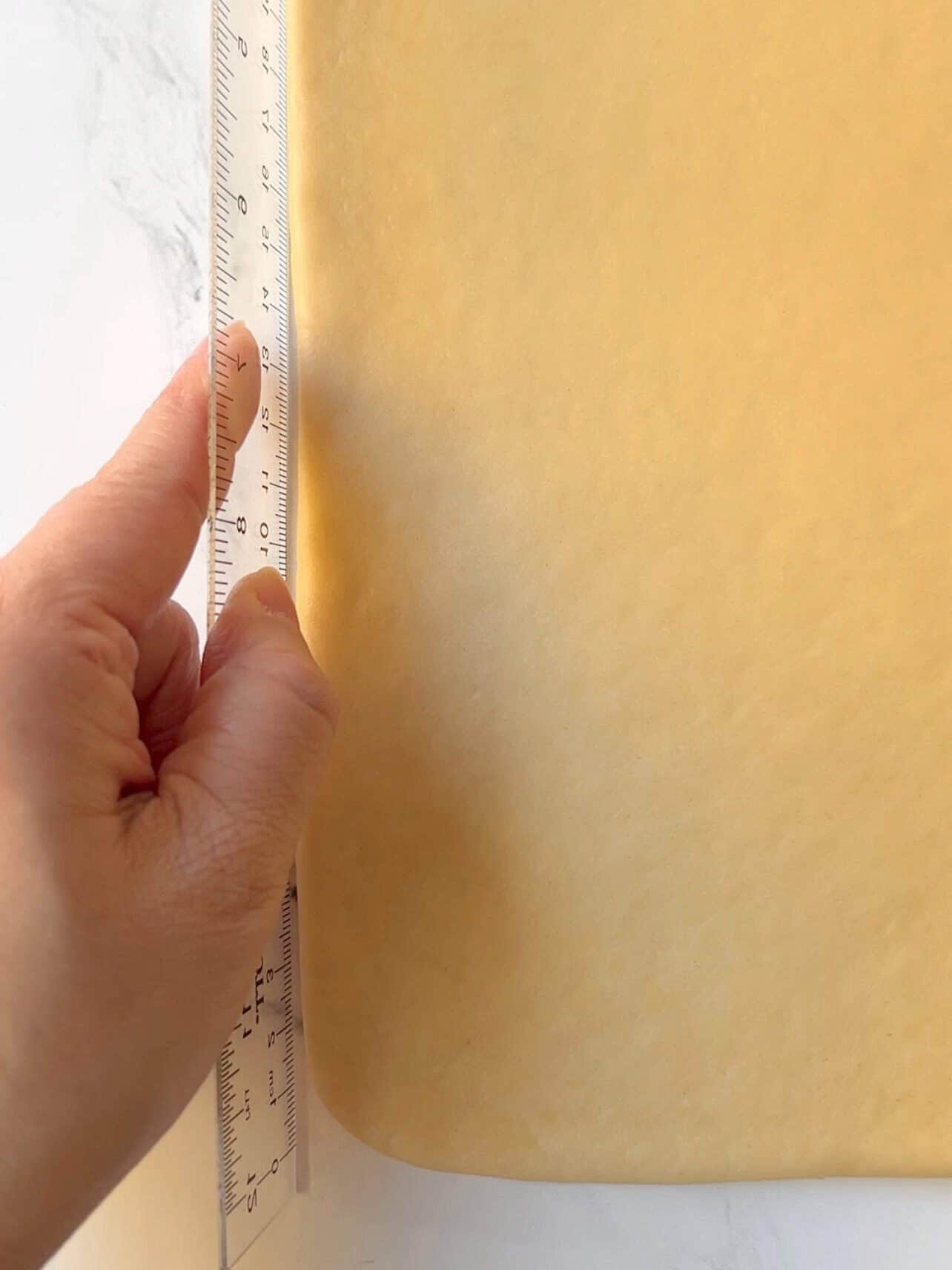 use of rulers to help achieve straight sides when rolling dough