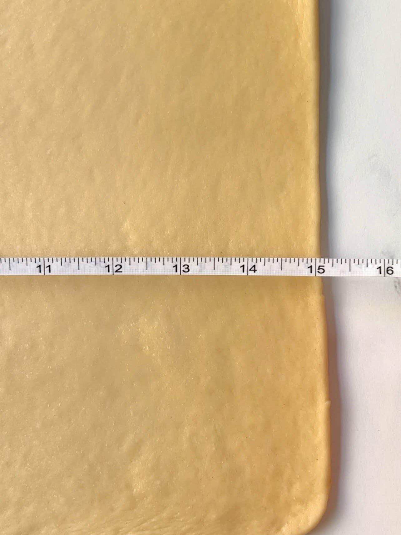 use of measuring tape to achieve thin cinnamon roll dough
