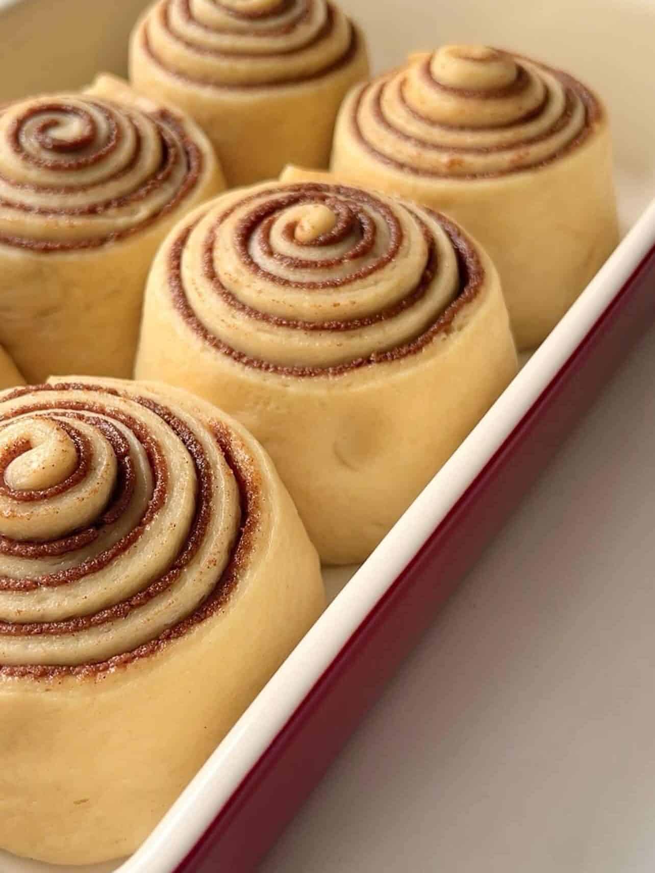 use of finger poke test to determine Cinnabon copycat cinnamon roll is ready for baking